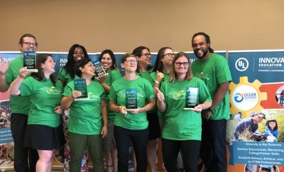 2018 ULIEA winners at the August 2018 Winners Summit, posing in ULIEA shirts with their awards displayed in hand.