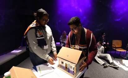 Youth Climate Summit Program participants with model homes.