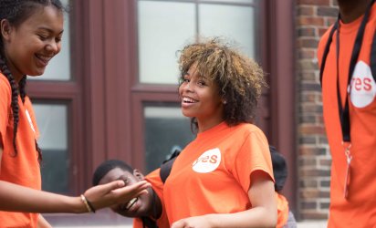 Three Youth Energy Squad participants in orange YES shirts all smiling