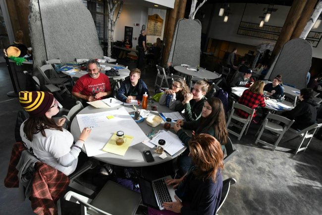 Youth Climate Summit Participants at round tables in a  workshop session.